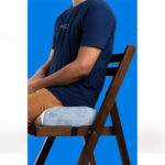 A person sitting on a Lumbarest cooling gel lumbar pillow