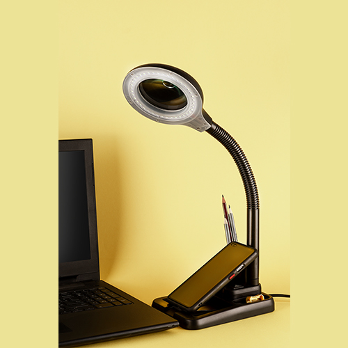 MagniGlow lamp with adjustable magnifying glass