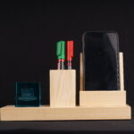 A Pen holder with two pants and a slot for a mobile phone with a crystal cube
