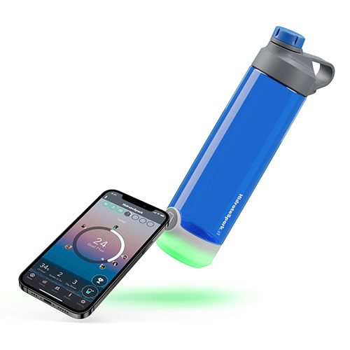 HidrateSpark tap bottle is lying horizontally next to a smartphone