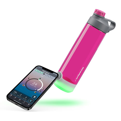 HidrateSpark tap bottle is lying horizontally next to a smartphone